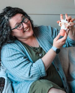 Dusti Murray holds a mini pelvis and baby.